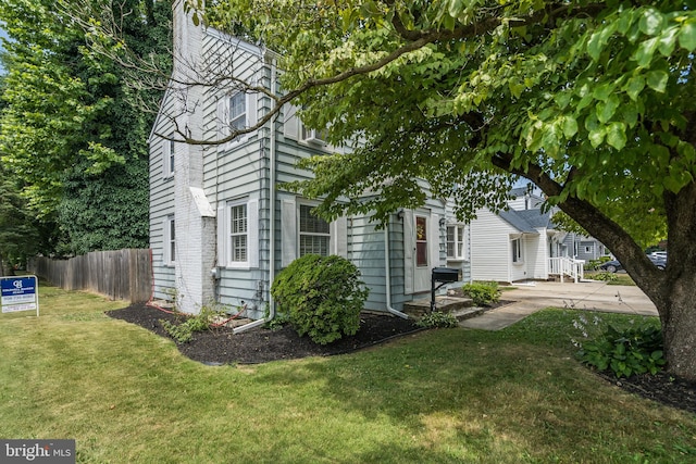 view of home's exterior featuring a yard and a patio area