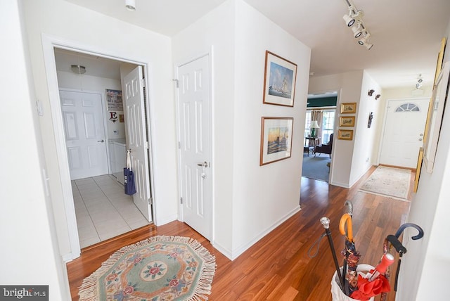 hall featuring hardwood / wood-style floors and rail lighting