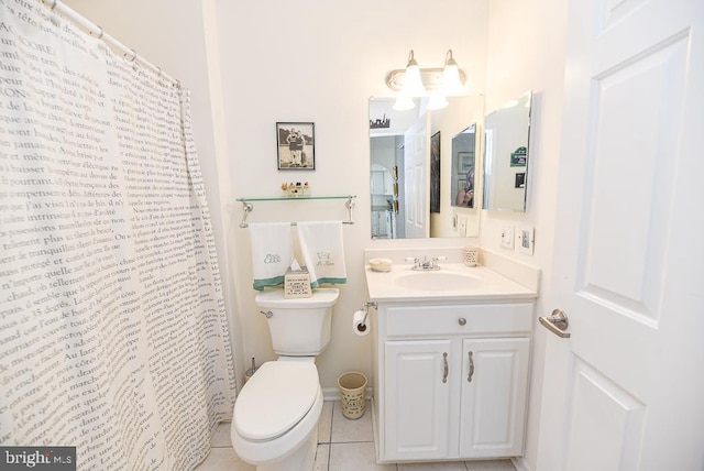 bathroom featuring tile patterned flooring, vanity, and toilet