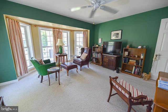 sitting room with light carpet and ceiling fan