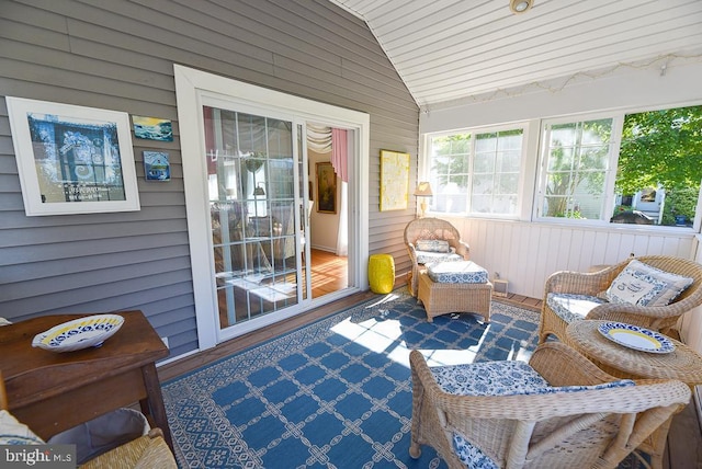 sunroom featuring vaulted ceiling