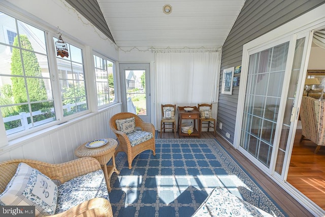 sunroom / solarium featuring vaulted ceiling