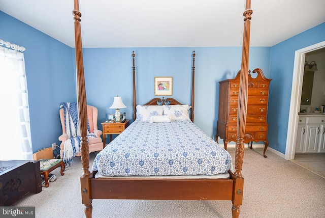 carpeted bedroom featuring ensuite bath