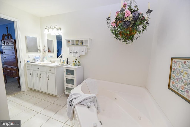 bathroom featuring a tub, tile patterned flooring, and vanity