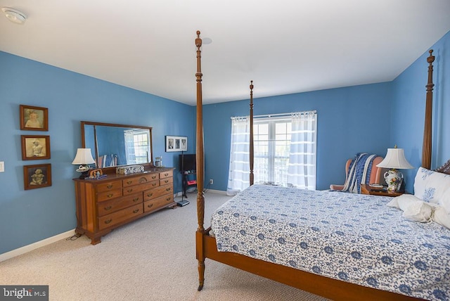 bedroom featuring light colored carpet