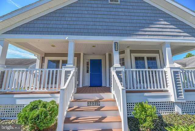 view of exterior entry featuring a porch