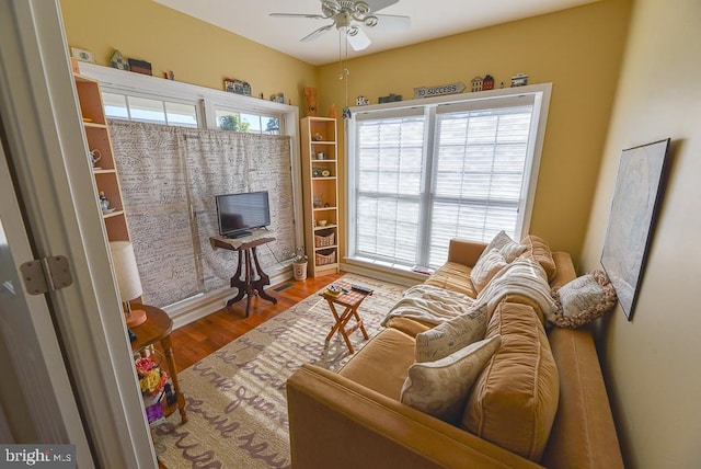 living area featuring hardwood / wood-style flooring, ceiling fan, and a healthy amount of sunlight