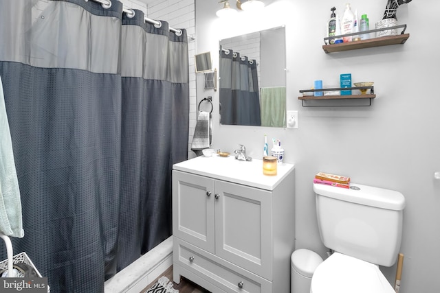 bathroom featuring vanity, curtained shower, and toilet