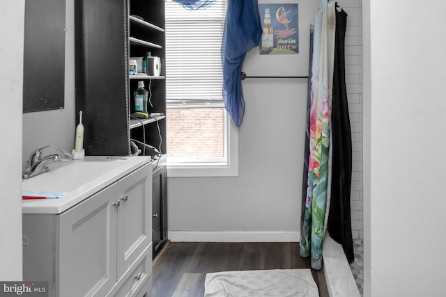 bathroom with vanity, hardwood / wood-style flooring, and walk in shower