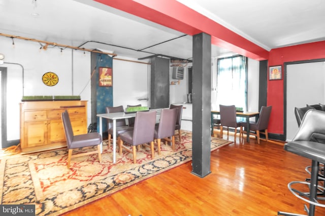 dining room featuring wood-type flooring and ornamental molding