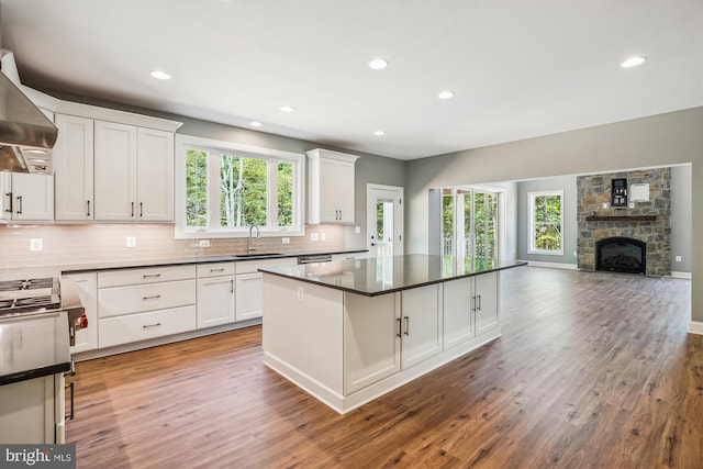 kitchen featuring white cabinetry, a fireplace, and light hardwood / wood-style floors