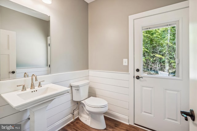 bathroom with a wealth of natural light, sink, hardwood / wood-style flooring, and toilet