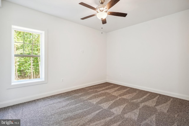 empty room featuring carpet flooring and ceiling fan