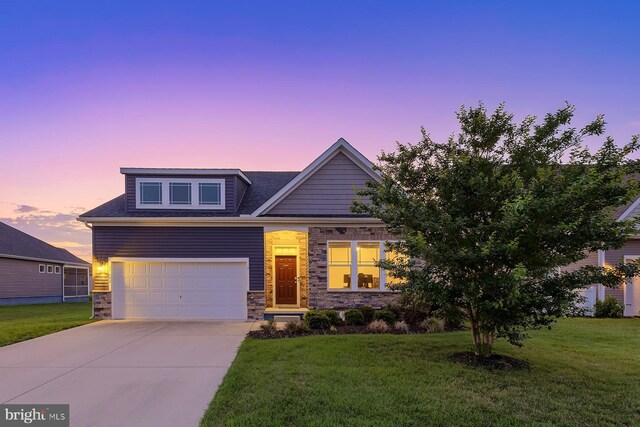 craftsman-style house with a garage and a yard