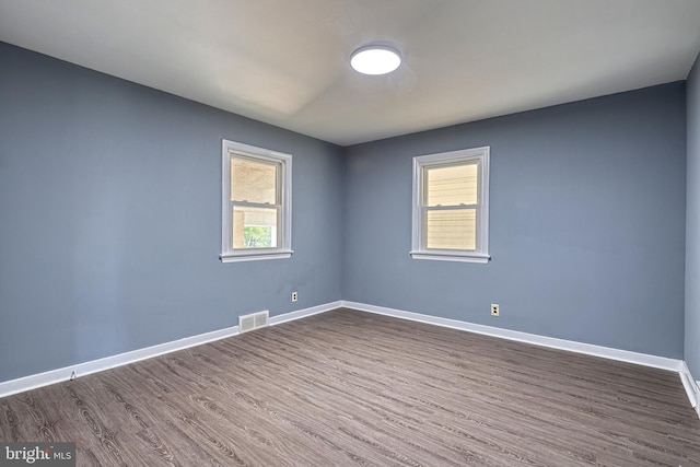 unfurnished room featuring dark wood-type flooring