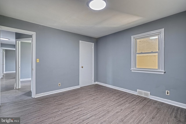 empty room with wood-type flooring