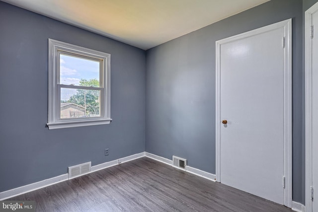 unfurnished room featuring dark hardwood / wood-style floors