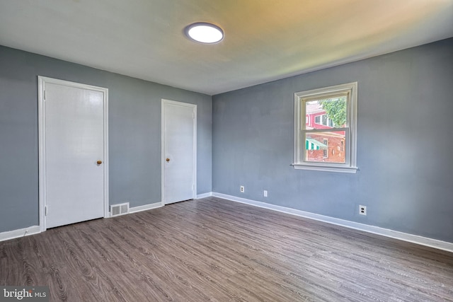 empty room featuring dark wood-type flooring