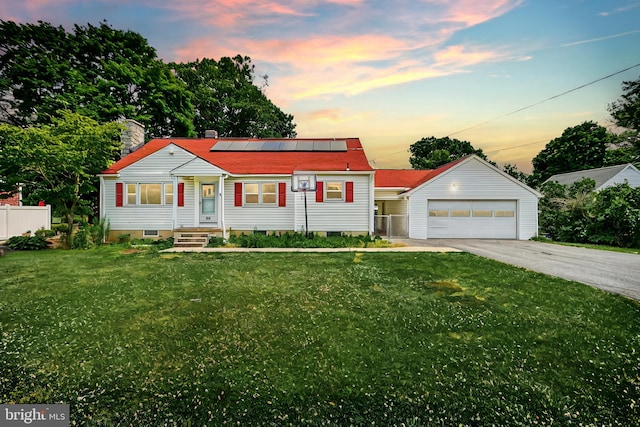 view of front of house featuring a lawn, a garage, and solar panels