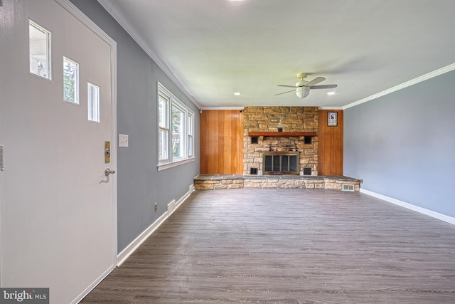 unfurnished living room with ceiling fan, dark hardwood / wood-style floors, ornamental molding, and a fireplace