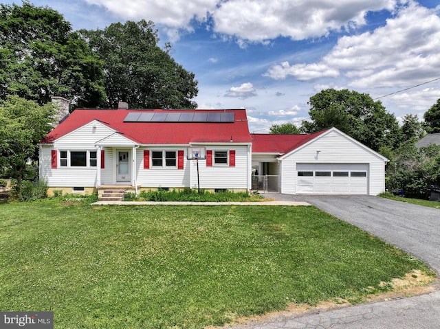 view of front of house featuring a front lawn, a garage, and solar panels