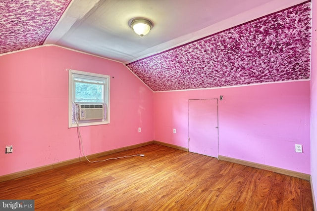 bonus room featuring hardwood / wood-style flooring, cooling unit, and lofted ceiling