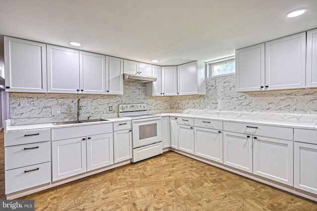 kitchen with electric range, sink, light stone countertops, decorative backsplash, and white cabinets