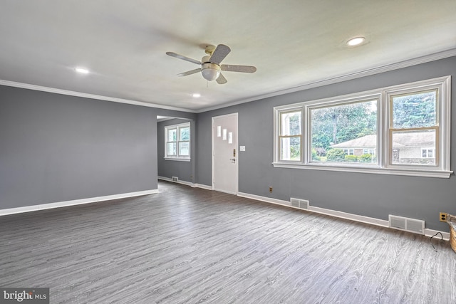 unfurnished room featuring ceiling fan, crown molding, and dark wood-type flooring