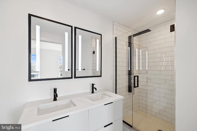 bathroom with vanity and a shower with shower door