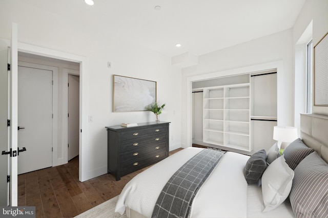 bedroom with a closet and dark wood-type flooring