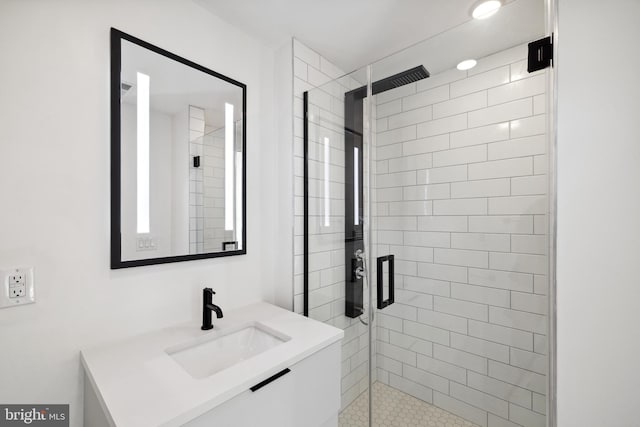 bathroom with vanity and a shower with shower door