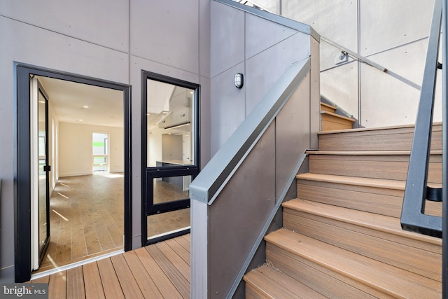 staircase featuring wood-type flooring