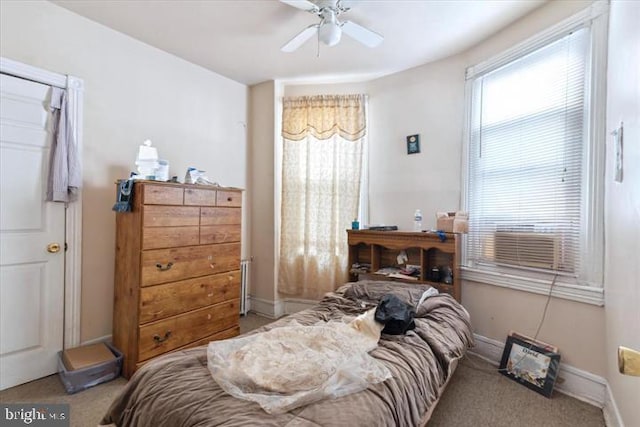 carpeted bedroom with ceiling fan and cooling unit