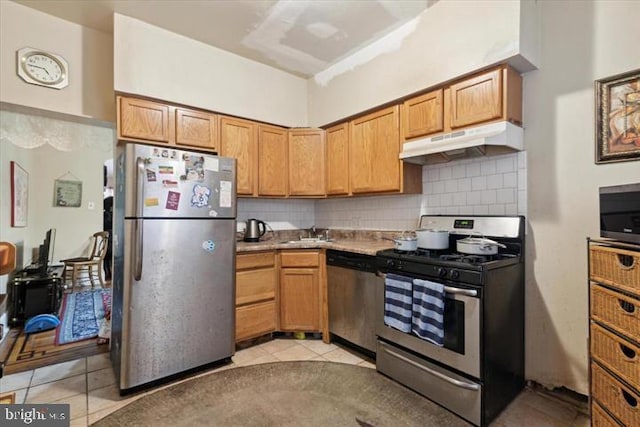 kitchen with tasteful backsplash, sink, light tile patterned floors, and appliances with stainless steel finishes