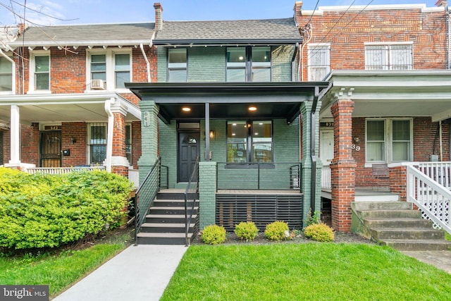 townhome / multi-family property with covered porch