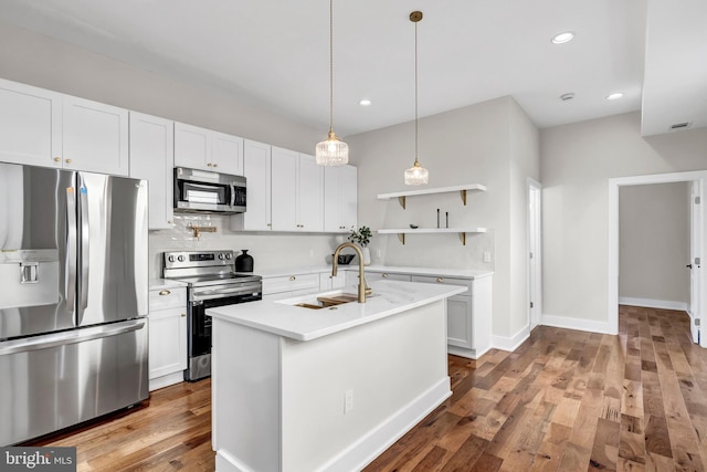 kitchen with white cabinets, sink, an island with sink, and appliances with stainless steel finishes