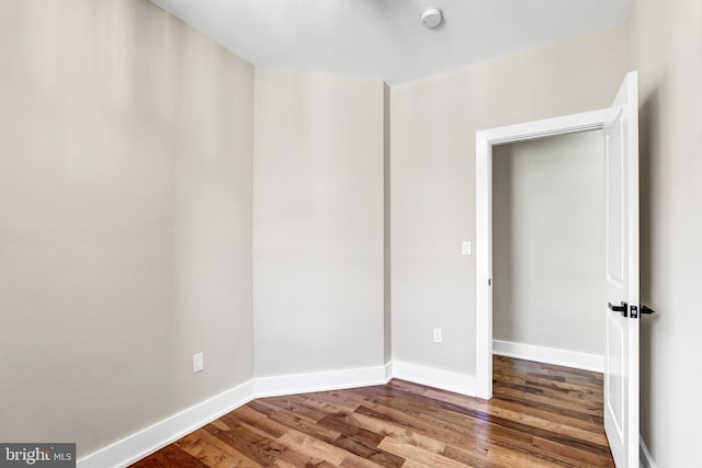 spare room featuring wood-type flooring