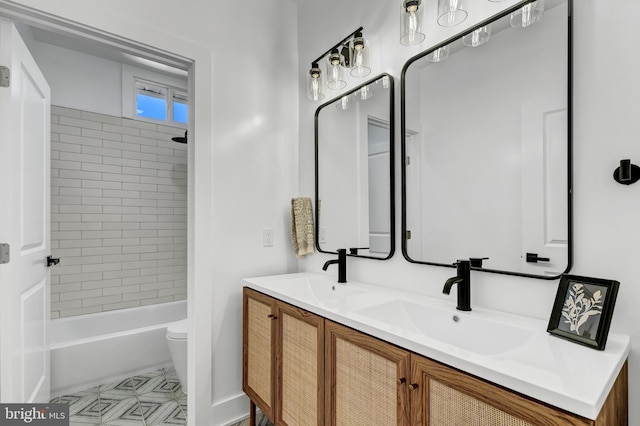 full bathroom with vanity, toilet, and tiled shower / bath combo