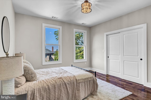 bedroom featuring dark hardwood / wood-style flooring and a closet