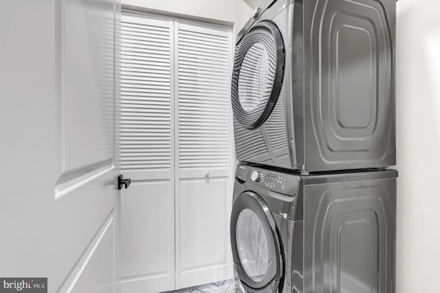 washroom featuring stacked washer / dryer