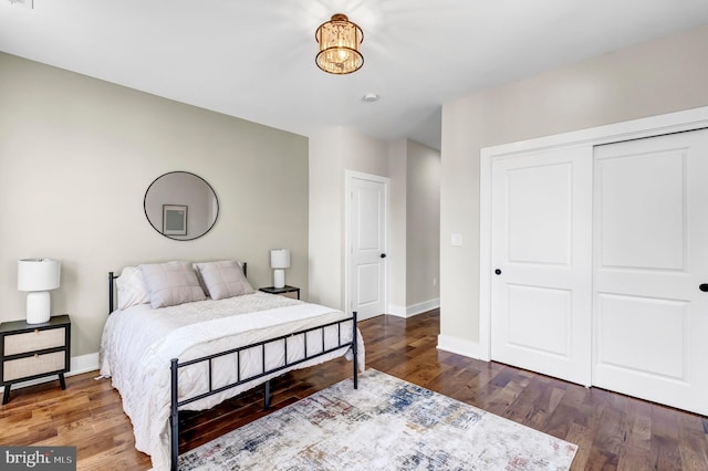 bedroom with a closet and dark hardwood / wood-style flooring