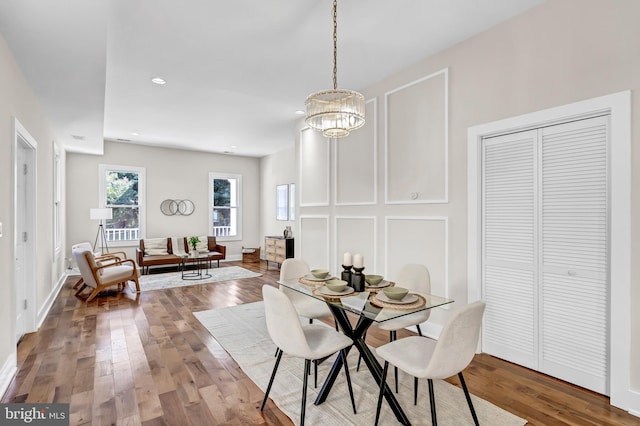 dining area with a chandelier and hardwood / wood-style floors