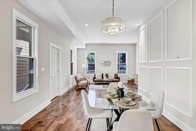 dining room featuring hardwood / wood-style flooring and a notable chandelier