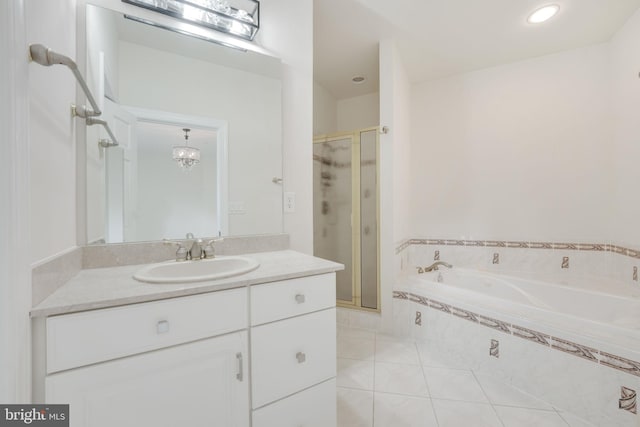 bathroom featuring a shower with door, vanity, and tile patterned flooring