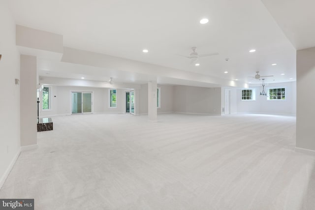 interior space featuring ceiling fan, a healthy amount of sunlight, and light colored carpet