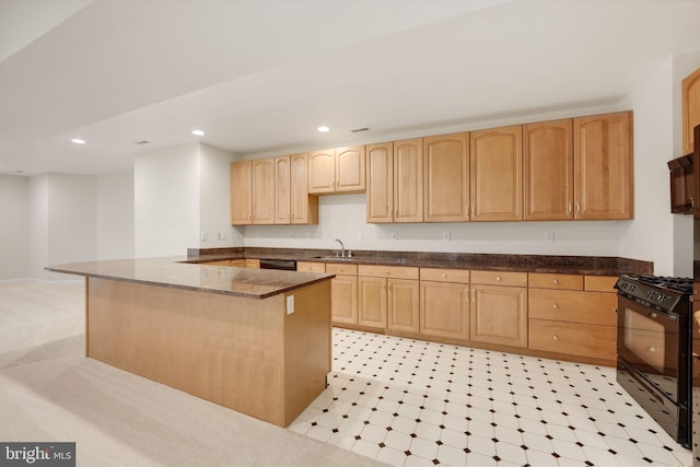 kitchen with dark stone countertops, black appliances, kitchen peninsula, sink, and light brown cabinetry