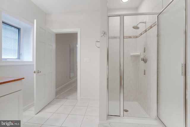 bathroom with tile patterned floors and a shower with door