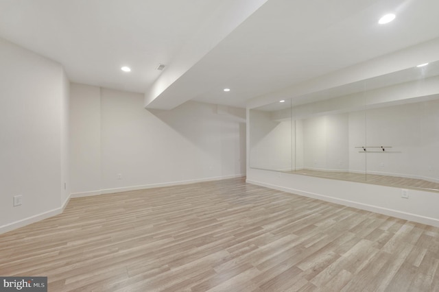 basement with light hardwood / wood-style floors