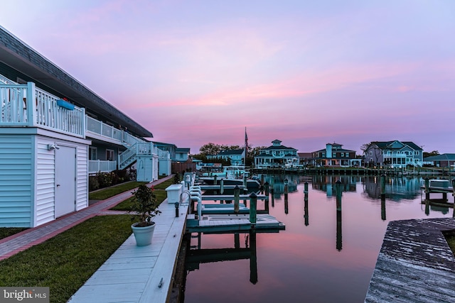 dock area with a balcony and a water view