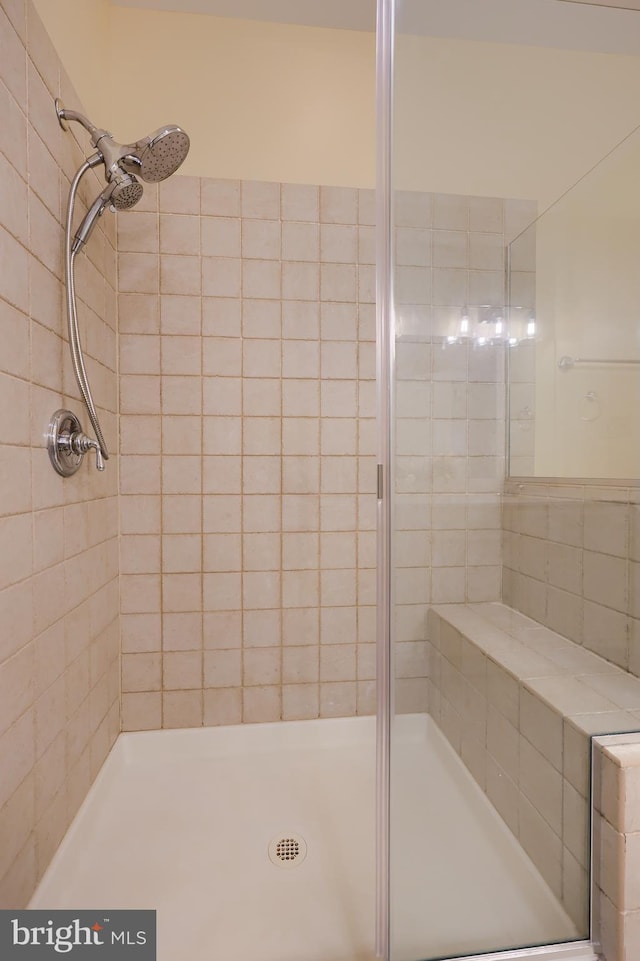 bathroom with tiled shower